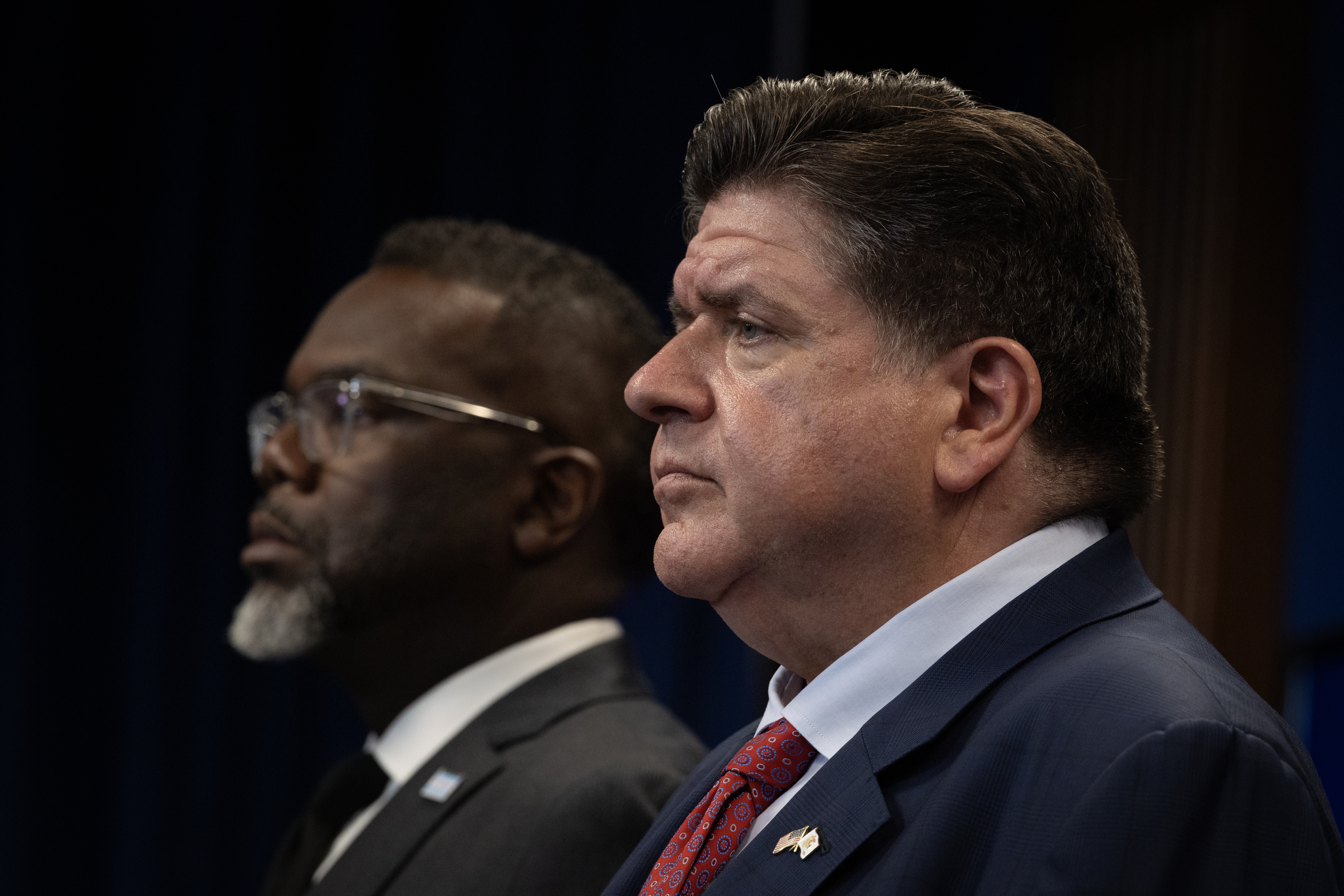 Illinois Gov. JB Pritzker, right, and Chicago Mayor Brandon Johnson are seen at a September press conference about President Trump